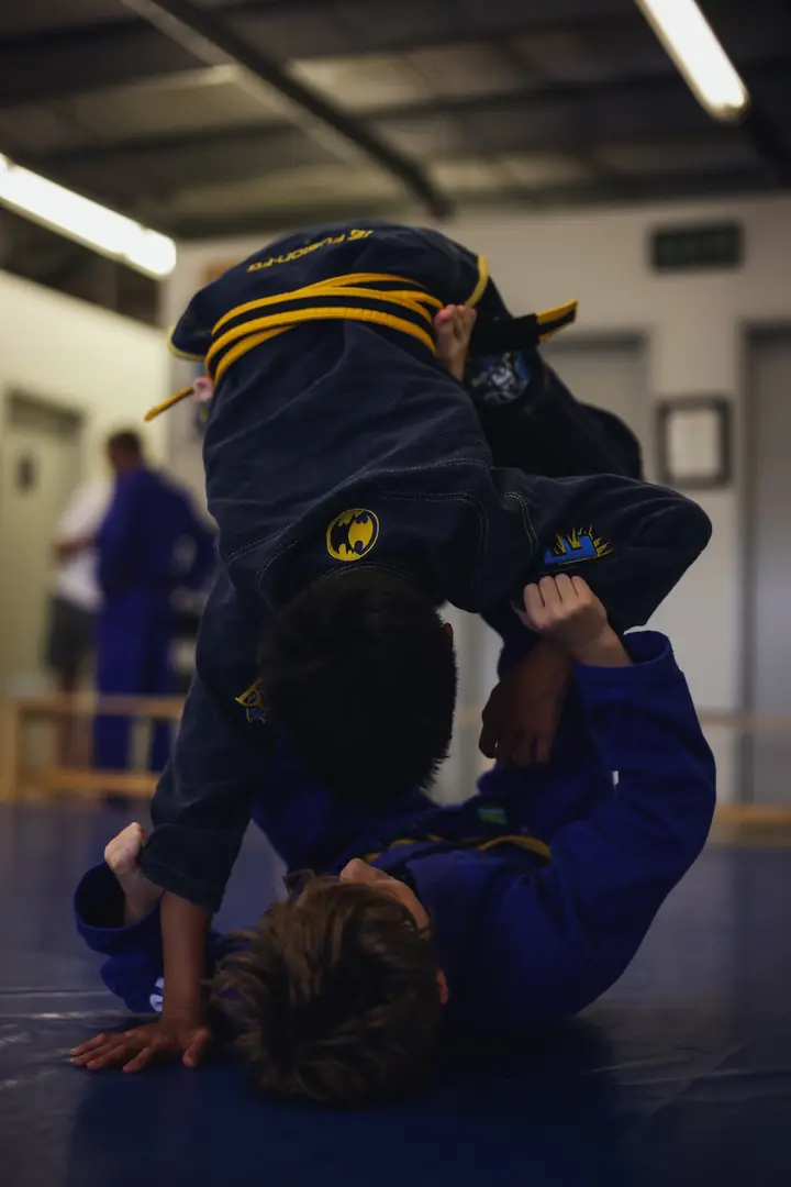 Two Kinjas teammates practise a safe inverted guard movement during class